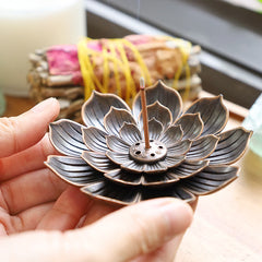 Six-Hole Lotus Incense Burner held in palm, tiered metal petals with lit incense, relaxing