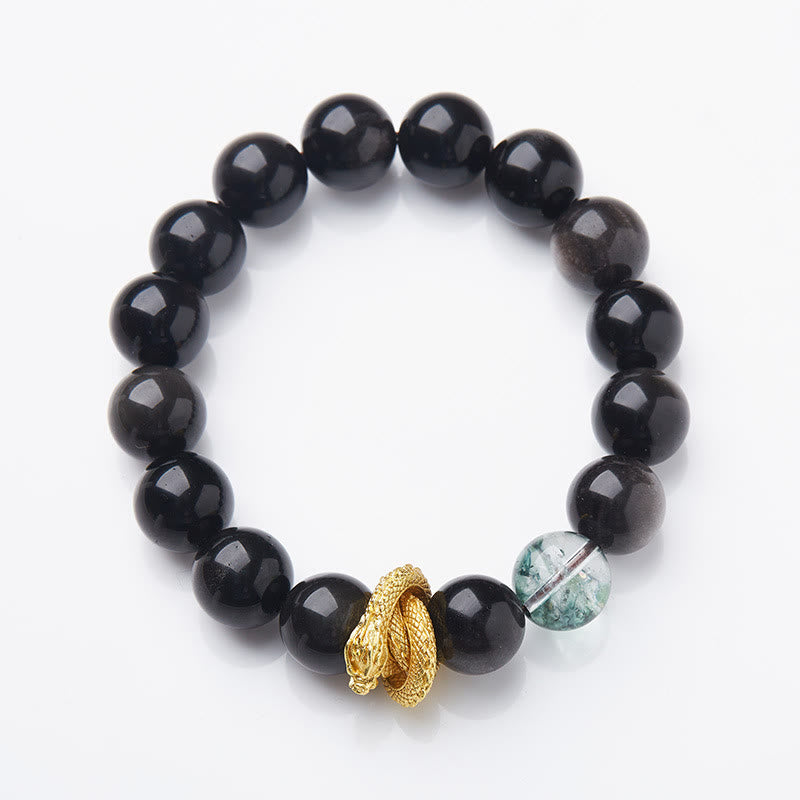 Silver Sheen Obsidian Dragon Bracelet – Flat lay with glossy black beads, green inclusion accent and gold charm, protective