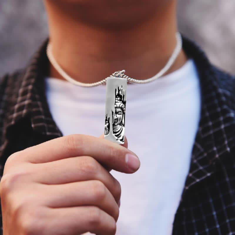 Tathagata Buddha Copper Amulet Necklace – person holding Buddha pendant near chest in white shirt, closeup, amulet