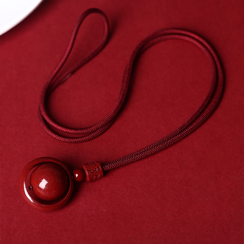 Cinnabar PiXiu Necklace – Full red cord layout flat on red background, cinnabar blessing bead necklace
