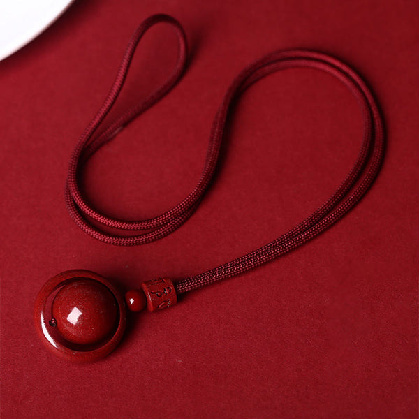 Cinnabar PiXiu Necklace – Full red cord layout flat on red background, cinnabar blessing bead necklace