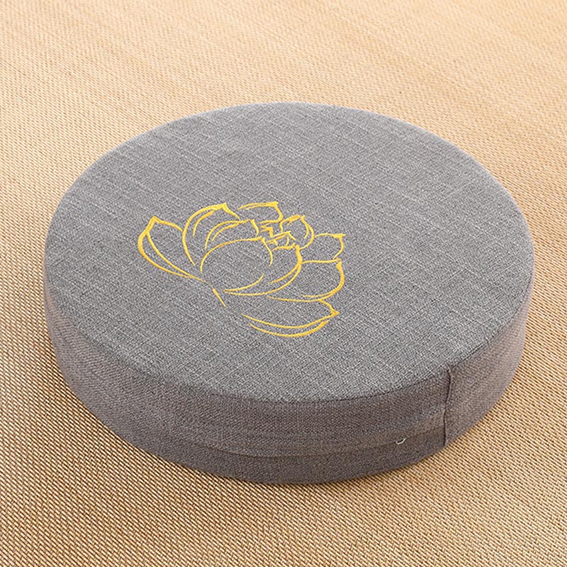 Gray Lotus Zafu - Round meditation cushion with gold lotus embroidery on tan woven mat