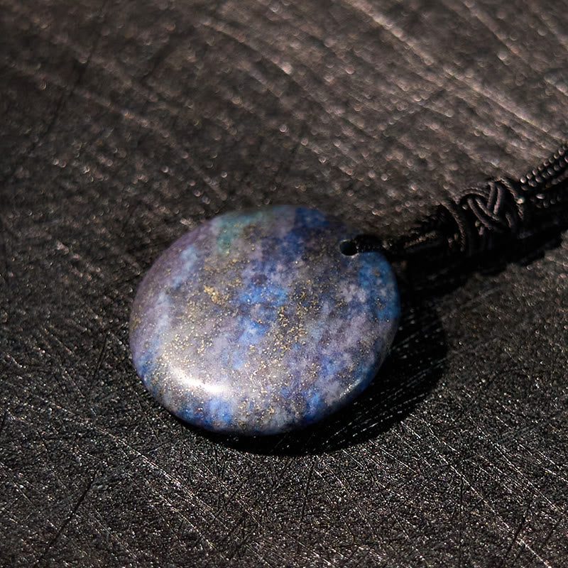 Yin Yang Crystal Necklace – Oval lapis lazuli pendant with deep blue coloring and golden pyrite flecks, polished smooth stone