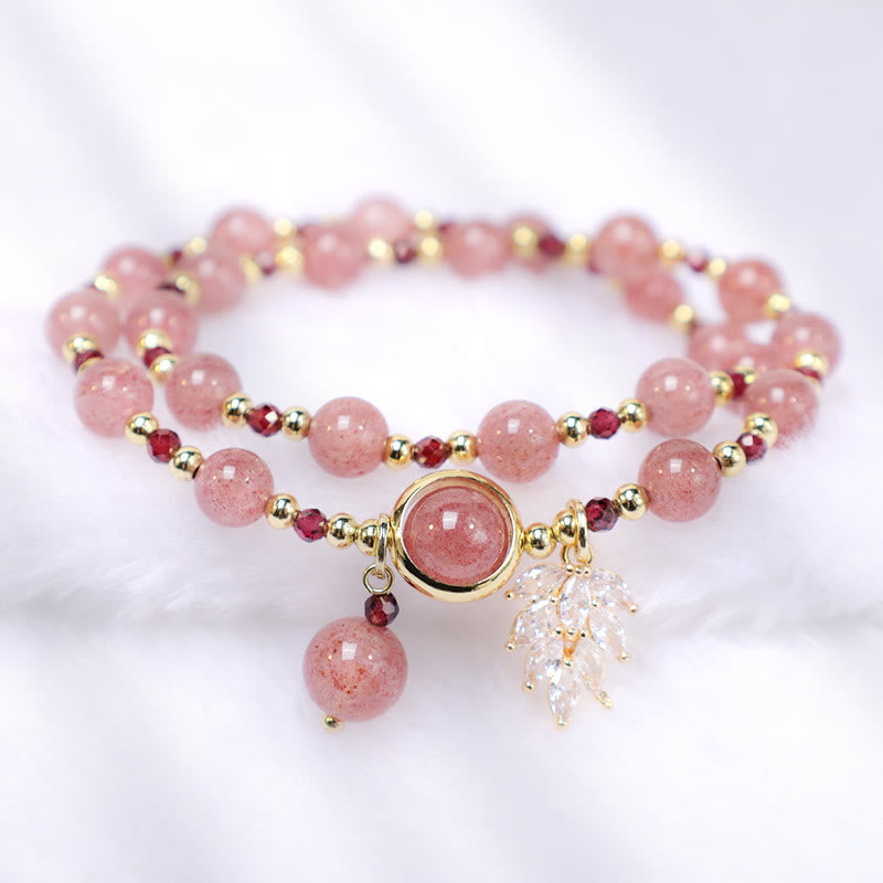 Strawberry quartz double-strand bracelet with natural pink inclusions garnet accent beads gold bezel centerpiece clear crystal leaf charm and pink bead drop