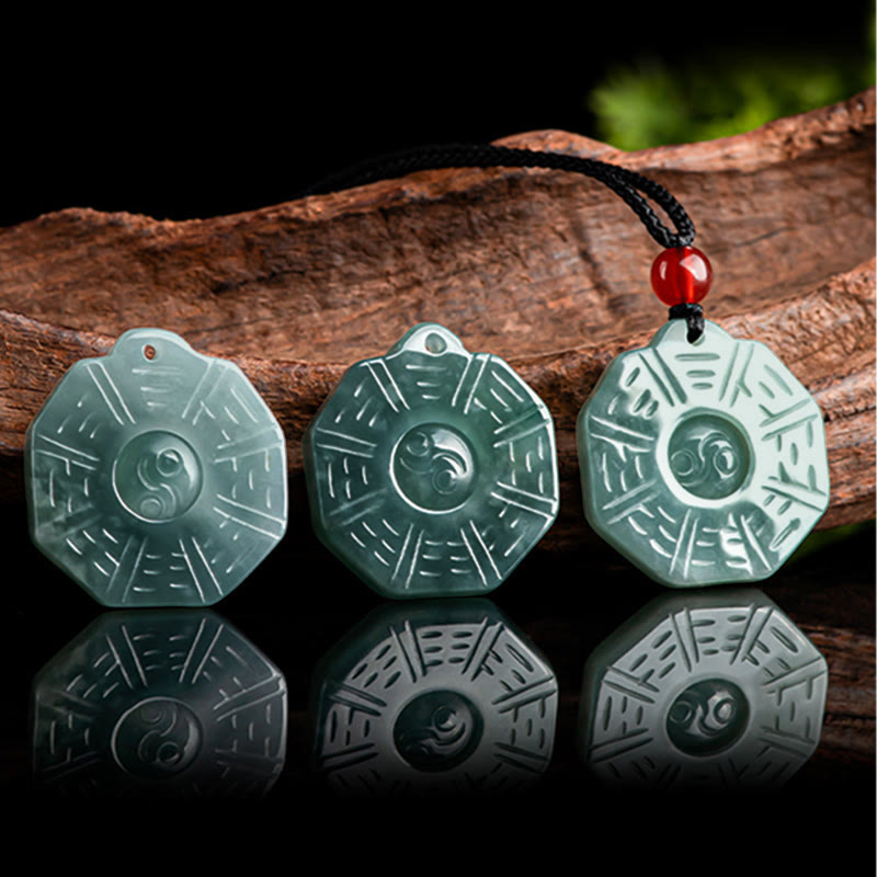 Natural Jade Bagua Yin Yang Pendant - Three jade bagua pendants displayed on wood, natural stone variation