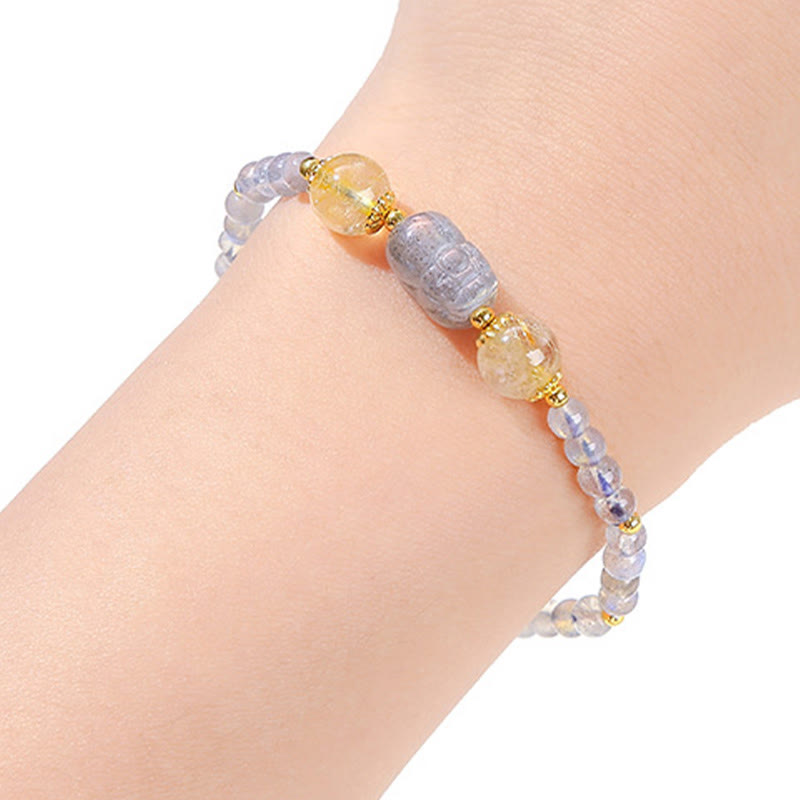 Moonstone Strawberry Quartz Tourmaline Bracelet – Moonstone bracelet with PiXiu worn on wrist, white background, wellness