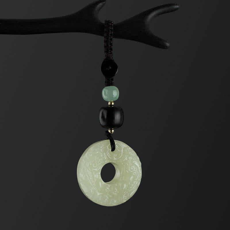 Jade PiXiu Peace Buckle Abundance Key Chain – Jade peace buckle leaning on wood slice, dark moody background