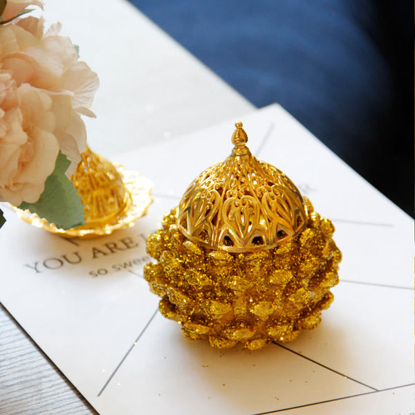 Gold Pine Cone Mini Incense Burner - Golden burner on geometric paper, cream flowers, boho decor