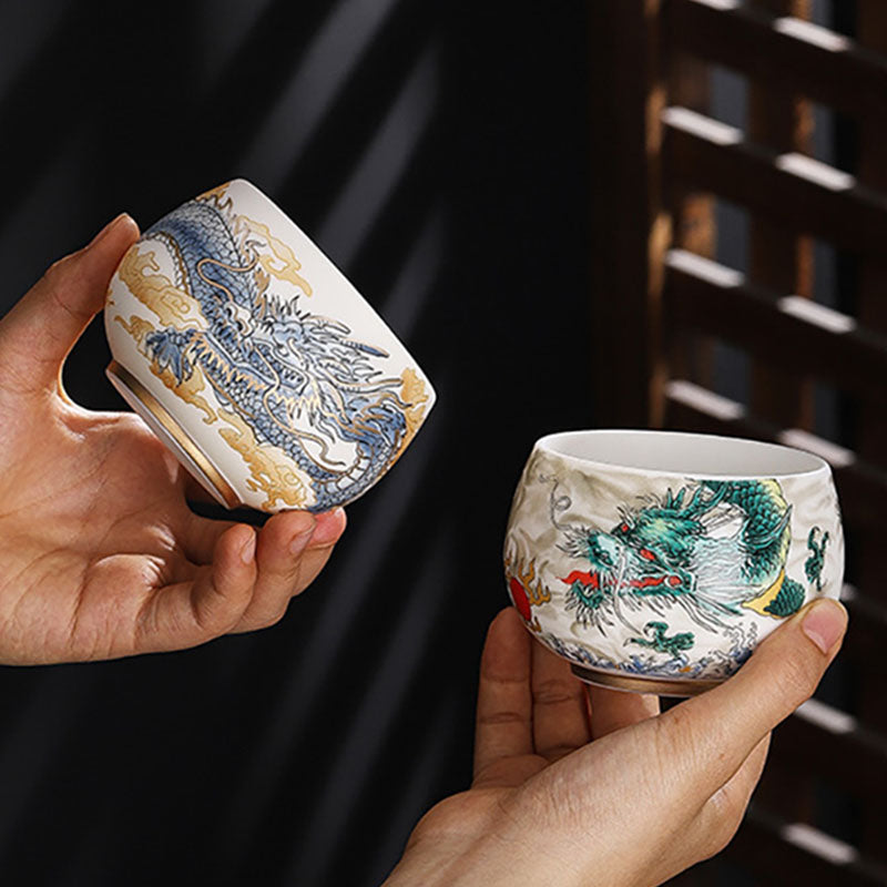 Dragon Cicada Ceramic Tea Bowl - pair held in hands: blue-gold dragon on smooth and green-red on textured