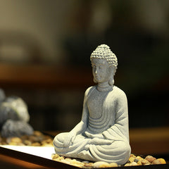 Sitting Meditation Buddha Sandstone Statue – side angle dark tray white sand, texture, tranquil