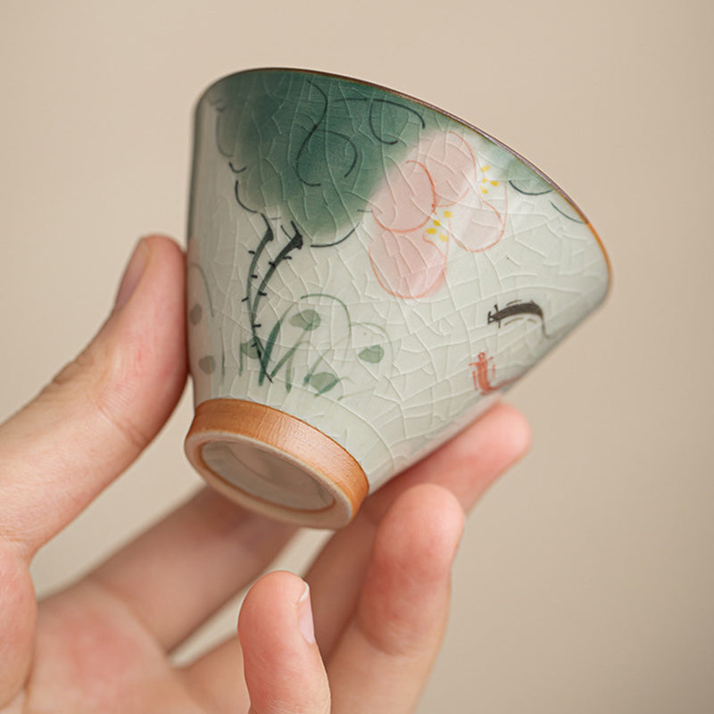 Persimmon Koi Fish Cup – held in hand showing size and grip, ceramic kung fu tea