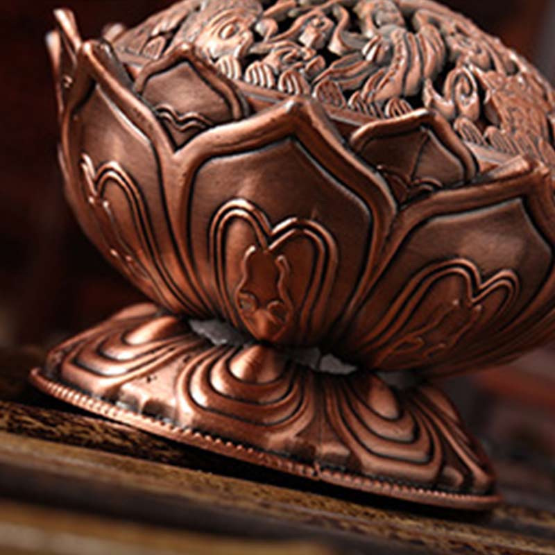 Lotus Shaped Incense Burner - Copper censer with robed figures on lid on wood surface, Sacred ambiance