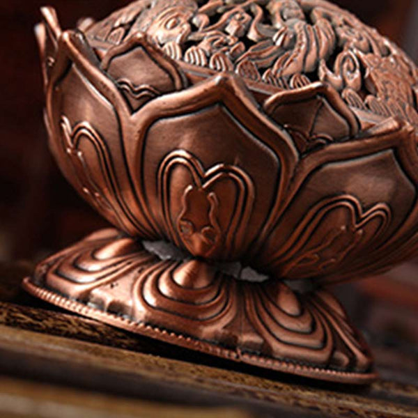 Lotus Shaped Incense Burner - Copper censer with robed figures on lid on wood surface, Sacred ambiance