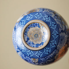 Lotus Chrysanthemum Ceramic Tea Cup - Underside view with gold floral medallion and geometric border, fine craft