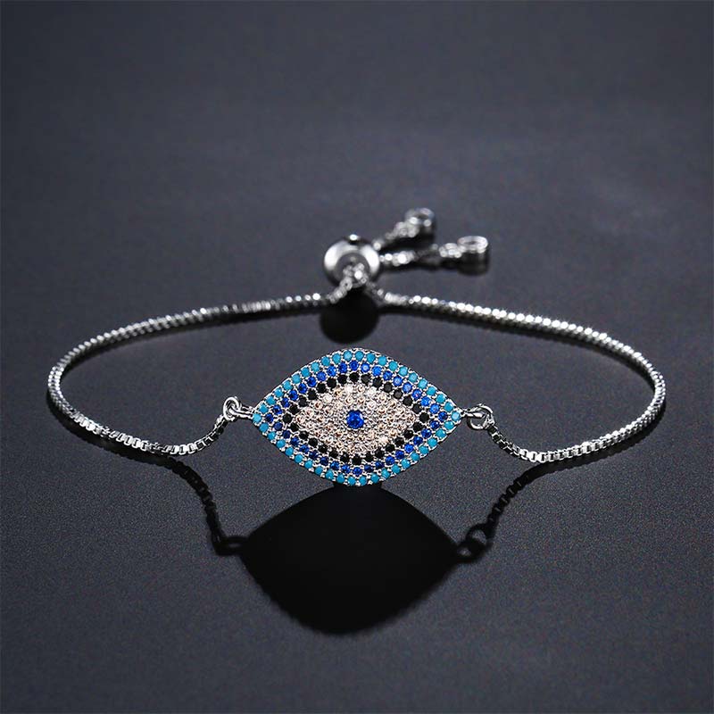 Evil Eye Healing Bracelet – Silver chain slider bracelet with blue turquoise evil eye on dark background