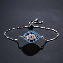 Evil Eye Healing Bracelet – Silver chain slider bracelet with blue turquoise evil eye on dark background