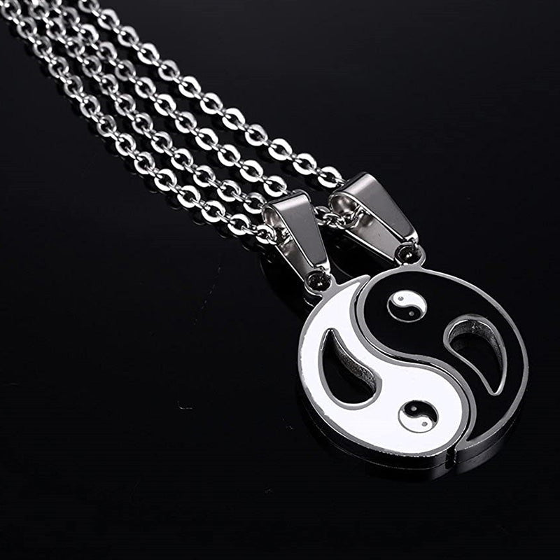 Yin Yang Pendant Couple Necklace Set - Two yin-yang interlocking pendants on silver chains, black background studio produc...
