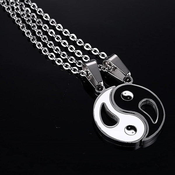 Yin Yang Pendant Couple Necklace Set - Two yin-yang interlocking pendants on silver chains, black background studio produc...