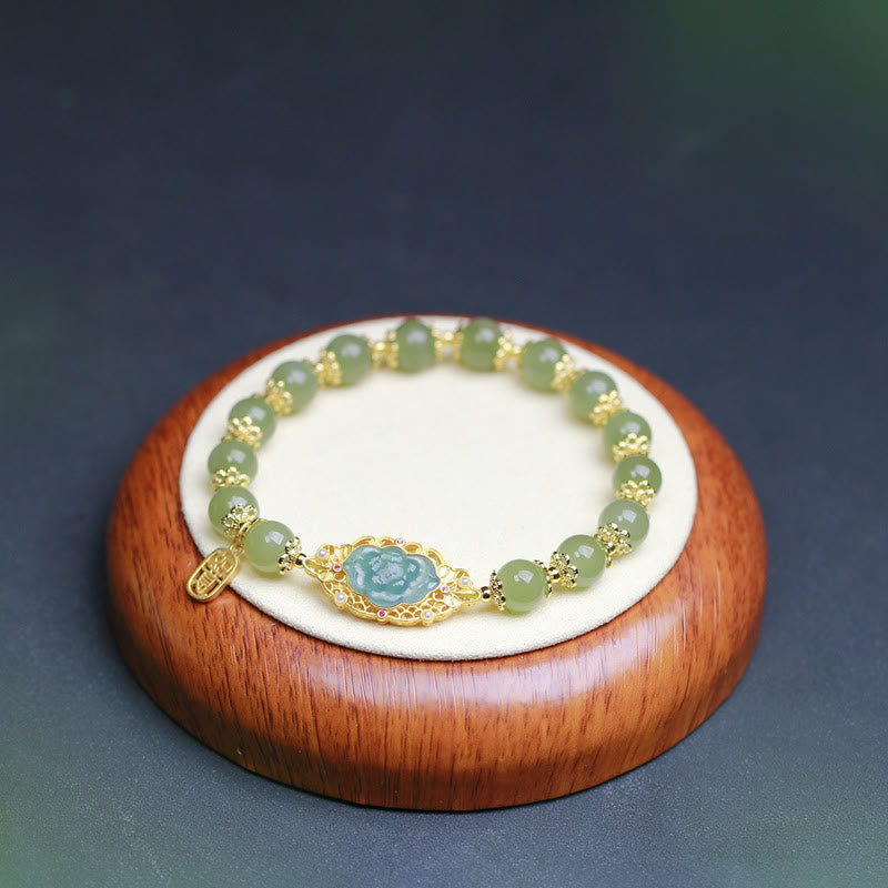 Hetian Jade Lotus Bracelet - centered on wooden velvet stand with gold filigree detail, Chinese jade bracelet