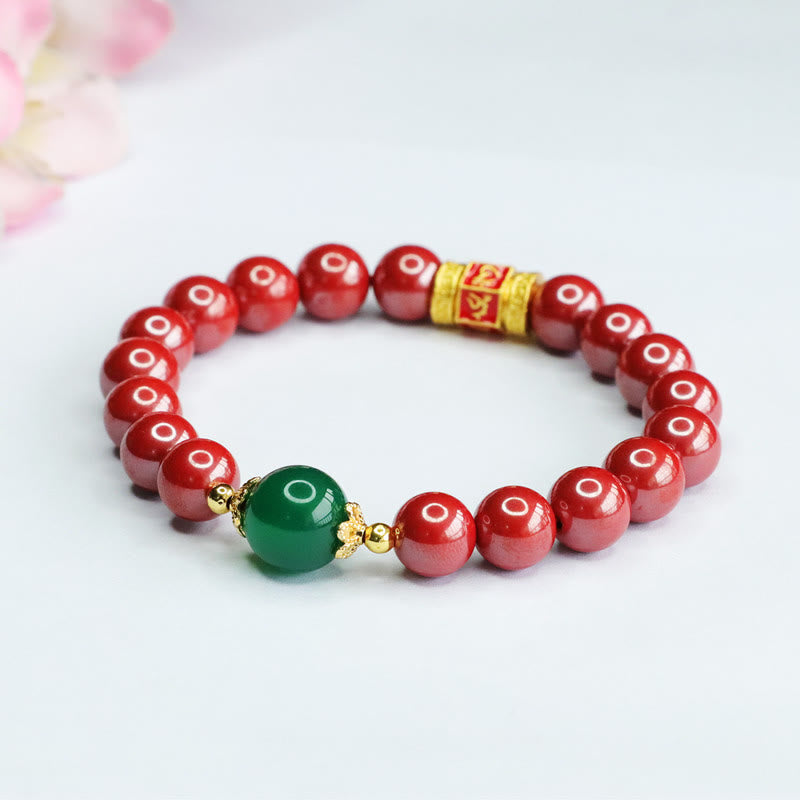 Cinnabar Agate Bracelet – Elevated angle on white with floral bokeh, red stone beads