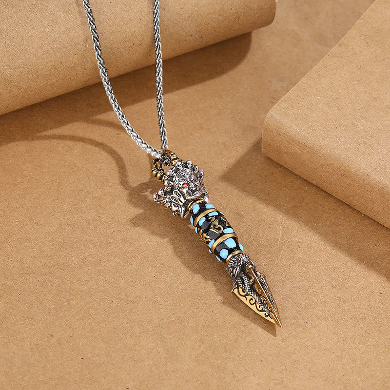 Tibetan Dzi Bead Dorje Pendant - Close-up on kraft paper showing deity crown and turquoise inlay bands, Tibetan necklace