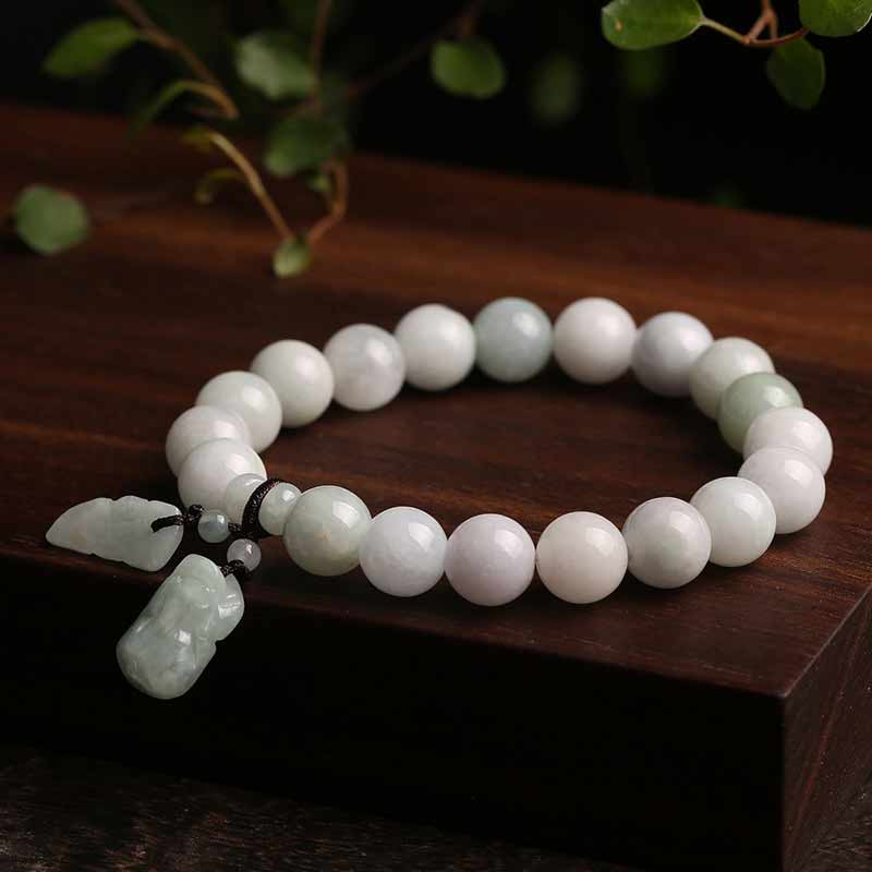 Natural Jade Pi Xiu Buddha Gourd Apple Success Bracelet – jade bracelet on dark wood with green leaves, zen style