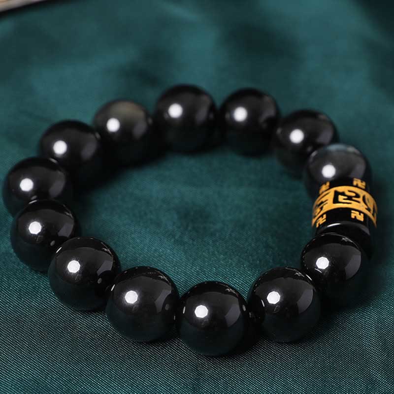 Rainbow Obsidian Bracelet – Overhead view of circular bead arrangement with gold mantra bead, healing crystal