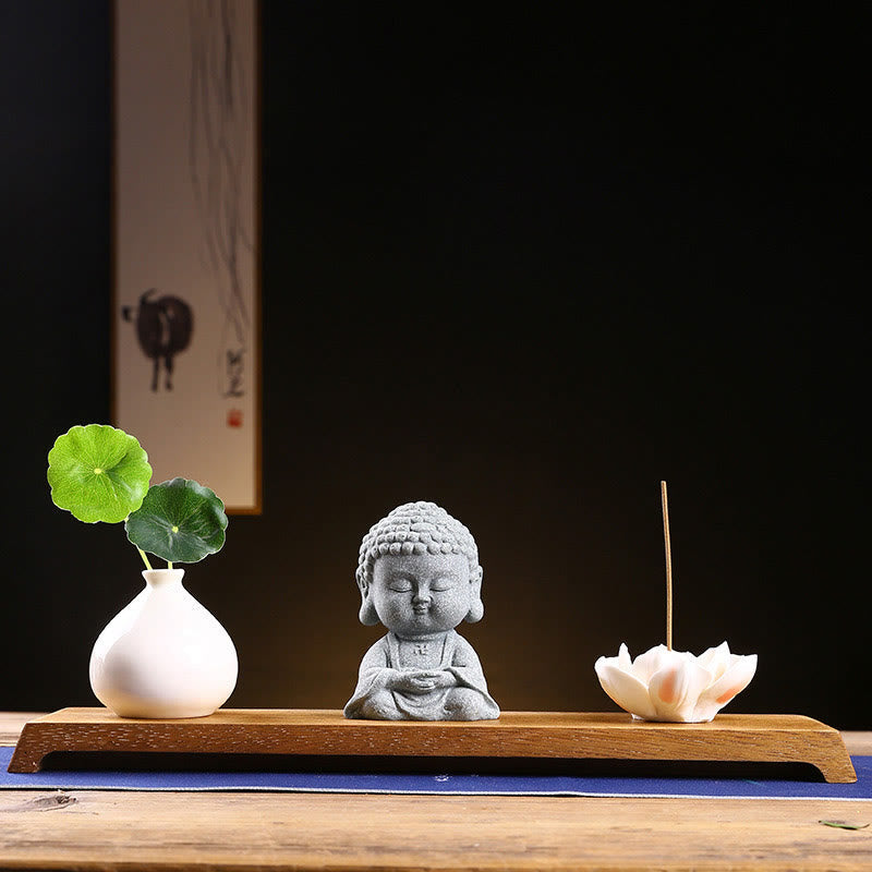 Meditation Praying Buddha Statue – dramatic side lighting on sandstone folds, sculptural shadow