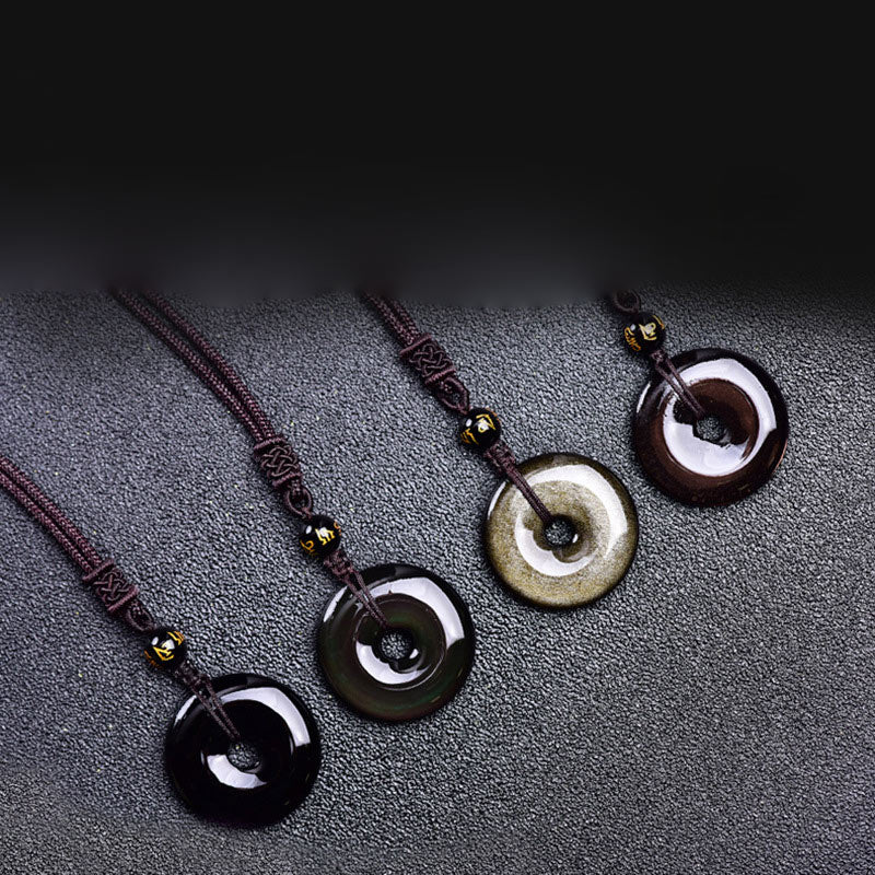 Tibetan obsidian protection necklace set showing four ping'an kou pendant varieties in glossy black smoky gray golden sheen and mahogany obsidian with gold-inscribed mantra beads on braided cords