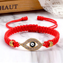Red braided cord evil eye bracelet with gold pave crystal eye, marble and wood styling