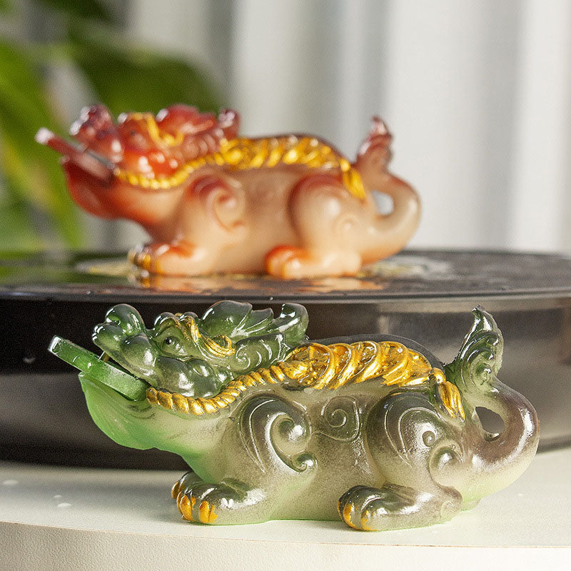 PiXiu Coin Tea Pet – Green and brown reclining PiXiu pair with plant and curtain background