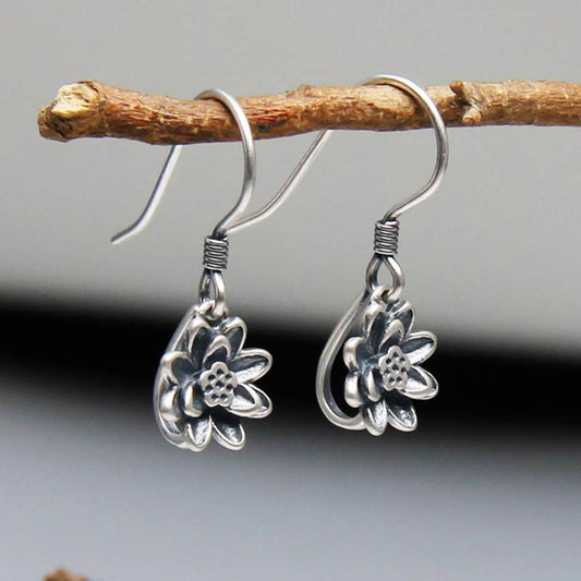 925 Sterling Silver Lotus Flower Enlightenment Earrings side angle on natural branch