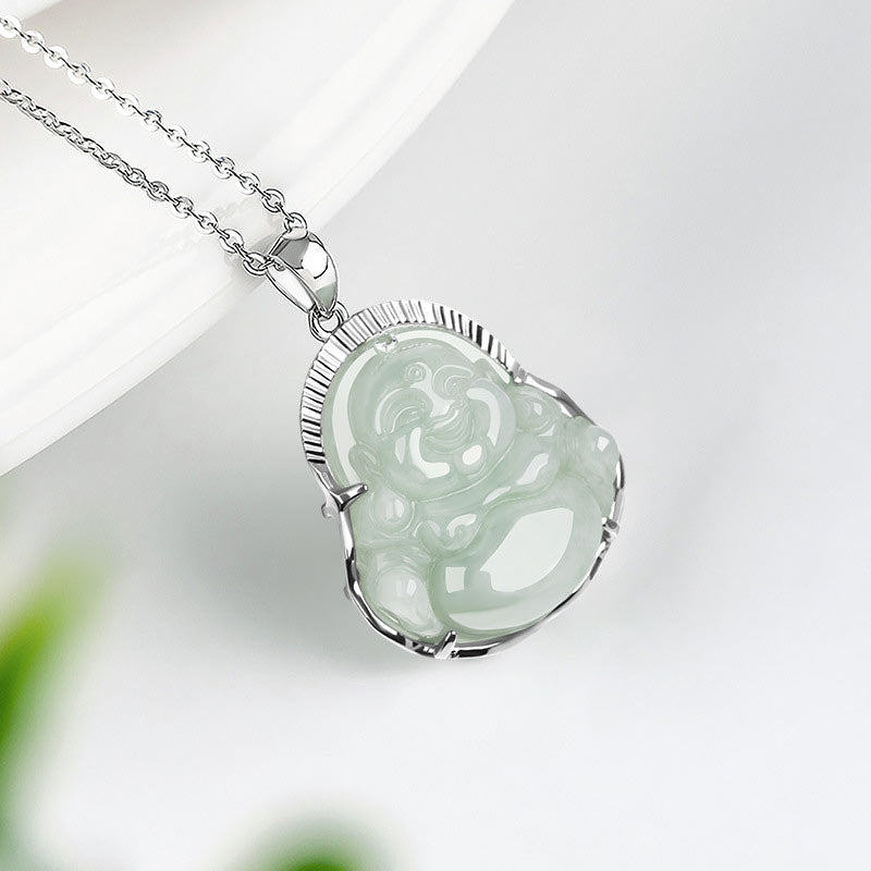 Jade Laughing Buddha Necklace - three-quarter view of translucent jade Buddha on ridged silver bezel with foliage, elegance