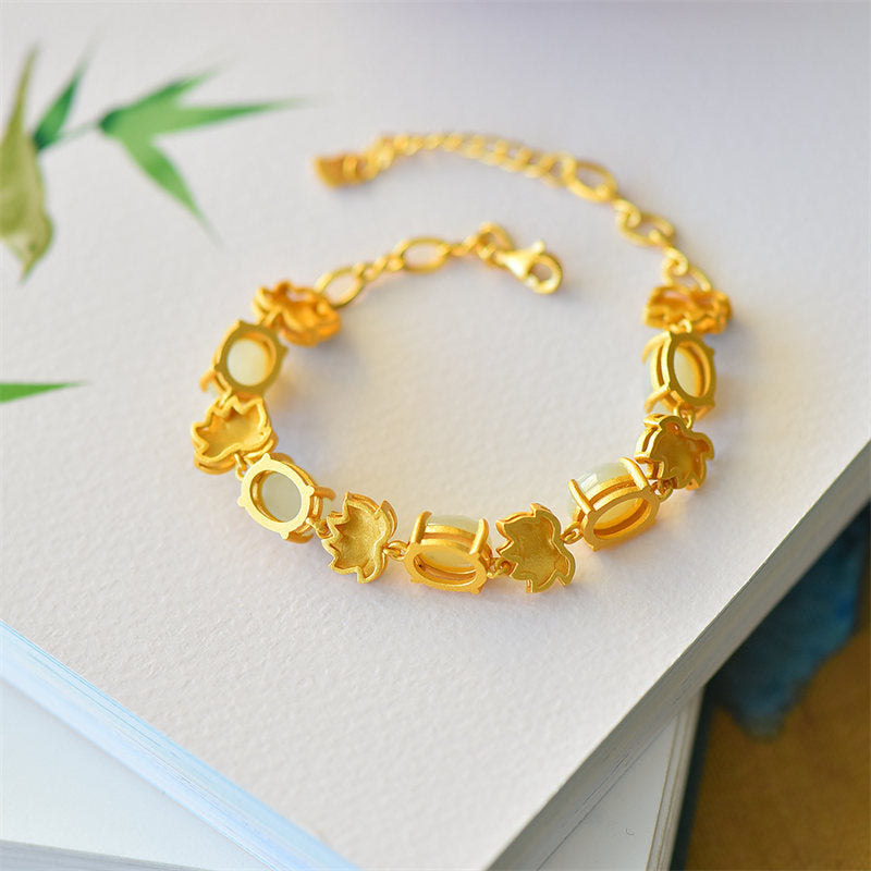 White Cyan Jade Lotus Bracelet - Matte gold lotus and jade links on white surface, bamboo accent, minimalist