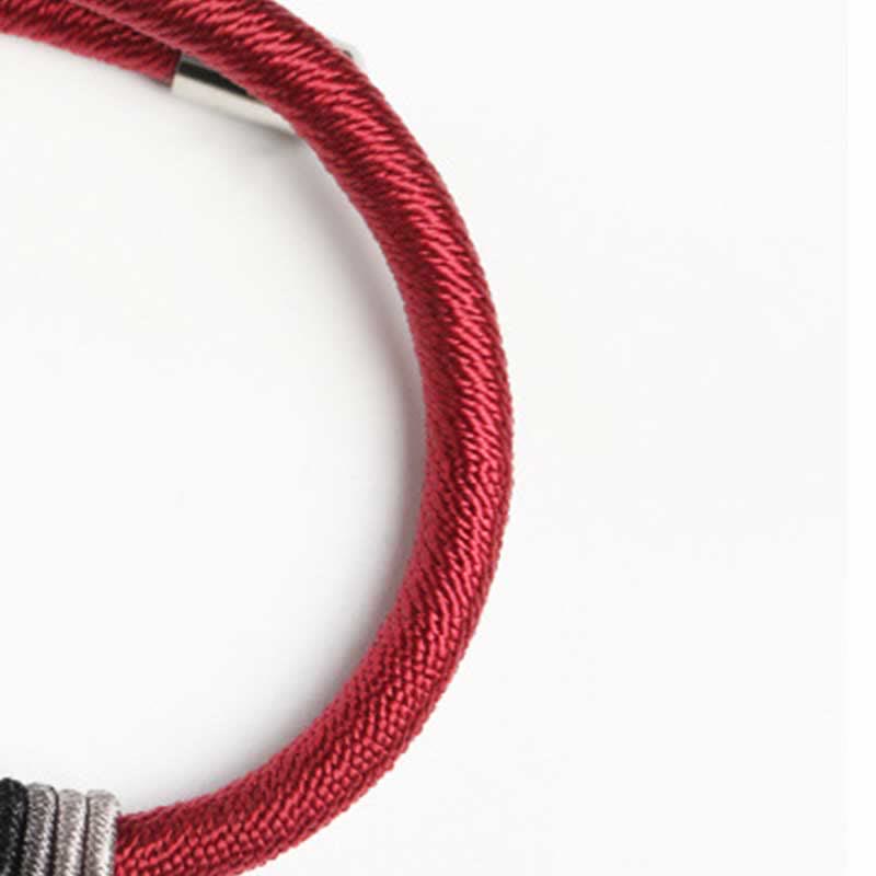 Om Mani Padme Hum Red Bracelet – Macro detail of braided red cord with mixed metal accent rings, woven cord bracelet