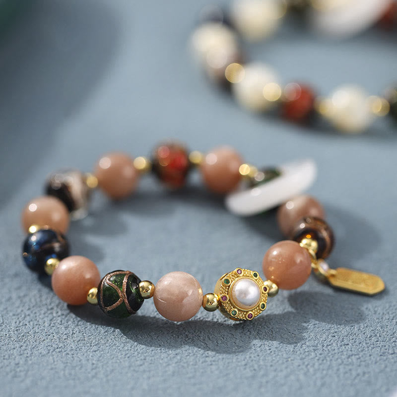 Liuli Glass Prayer Wheel Bracelet – Shallow focus close-up highlighting pearl setting and enamel work