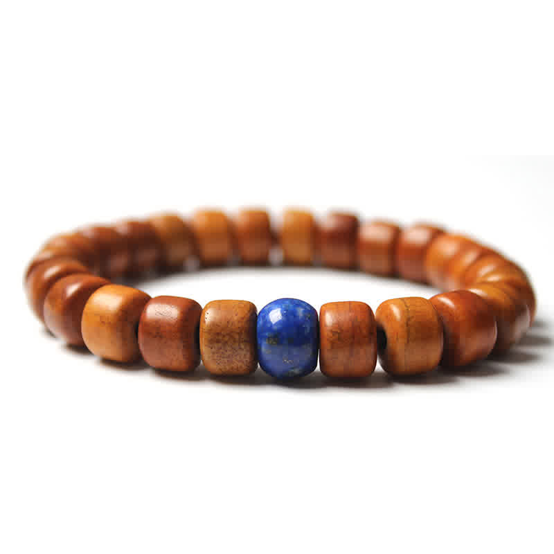 Tibetan Bone Beads Om Mani Padme Hum Bracelet – deep blue lapis lazuli focal on warm wood bead strand, natural stone bracelet