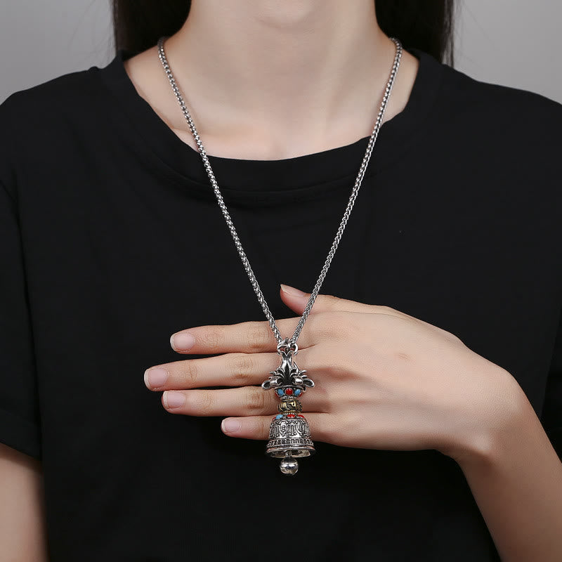 Tibetan Vajra Bell Pendant – Worn by model holding the bell charm, showing scale, meditation necklace