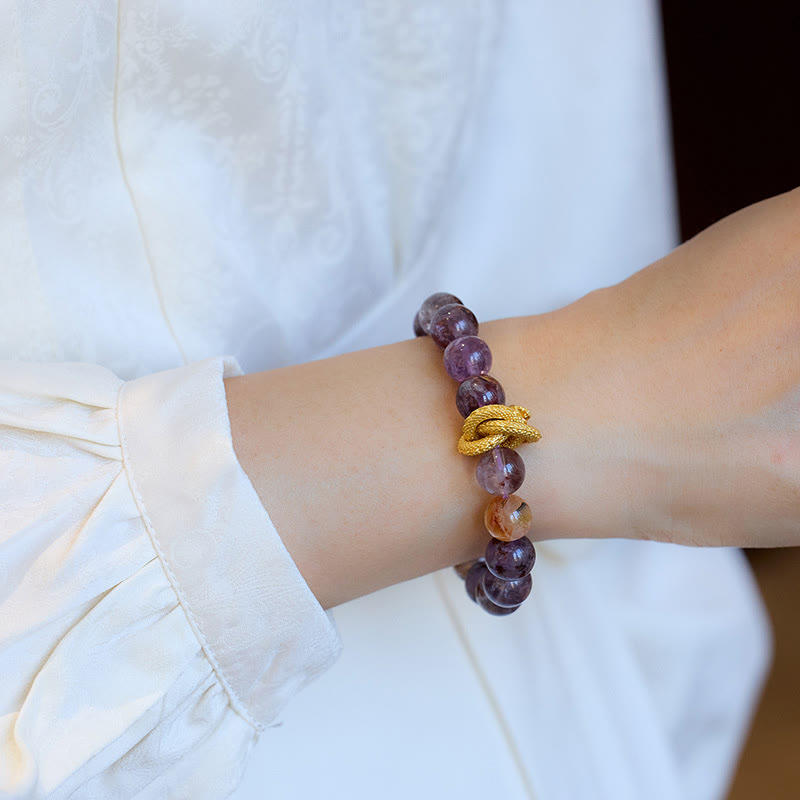 Purple Phantom Quartz Dragon Bracelet – Wrist-worn view over jacquard sleeve with gold dragon and amethyst, wise