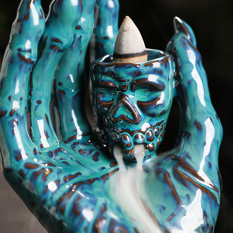 Ceramic Ghost Hand Skull Incense Burner – Close-up of turquoise skull with clawed hands, backflow smoke from mouth, glossy glaze