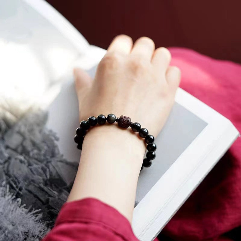 Gold Sheen & Rainbow Obsidian Fu Bracelet – worn with maroon top, lifestyle bead jewelry