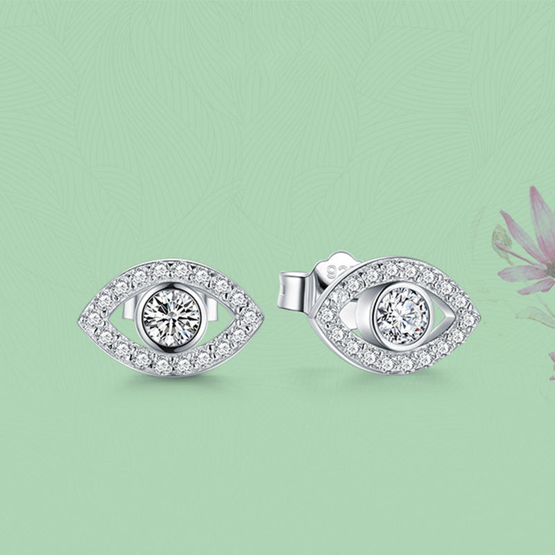 925 Silver Evil Eye Stud Earrings on Mint Green Background with Pink Floral Accent, Protection