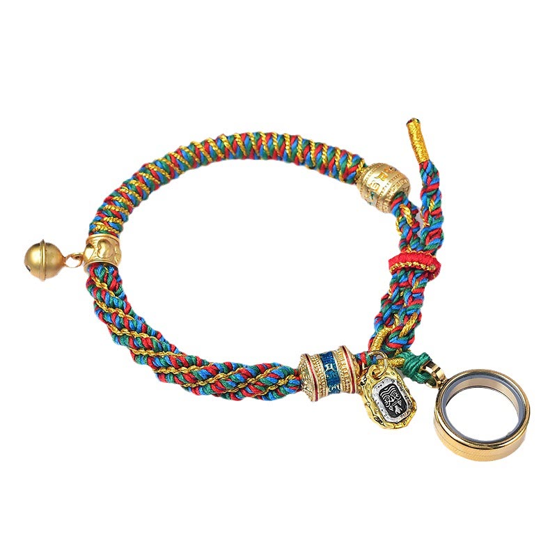 Braided cord bracelet with bell and beads, front view