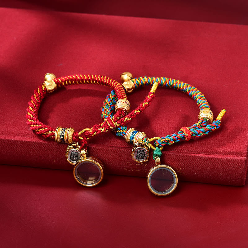 Two braided cord bracelets with decorative pendants
