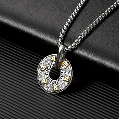 Tibetan Om Mani Padme Hum Peace Buckle Necklace – Silver disc pendant with Greek key border, gold Sanskrit inlays and black leather bail on black leather mat, three-quarter