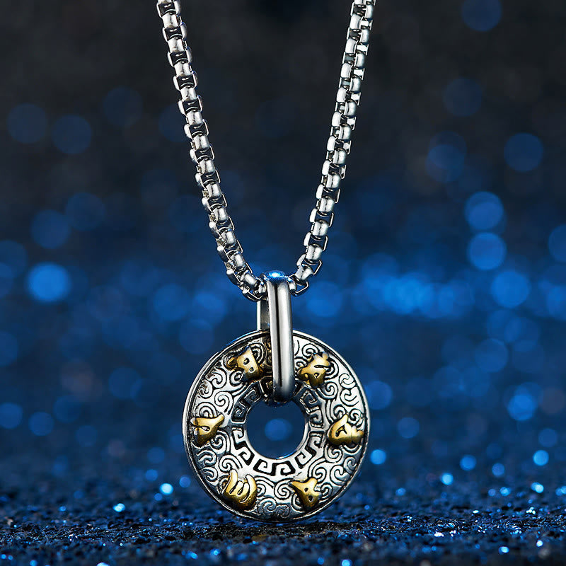 Tibetan Om Mani Padme Hum Peace Buckle Necklace – Silver pendant with spiral engravings and gold animal-head studs on box chain, deep blue glitter bokeh, frontal