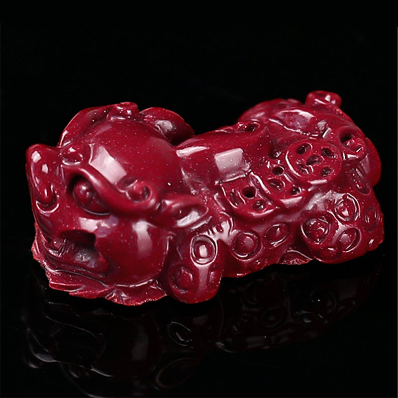 Tibetan Cinnabar PiXiu Bracelet – Close-up of carved red cinnabar PiXiu figure on black, prosperity charm
