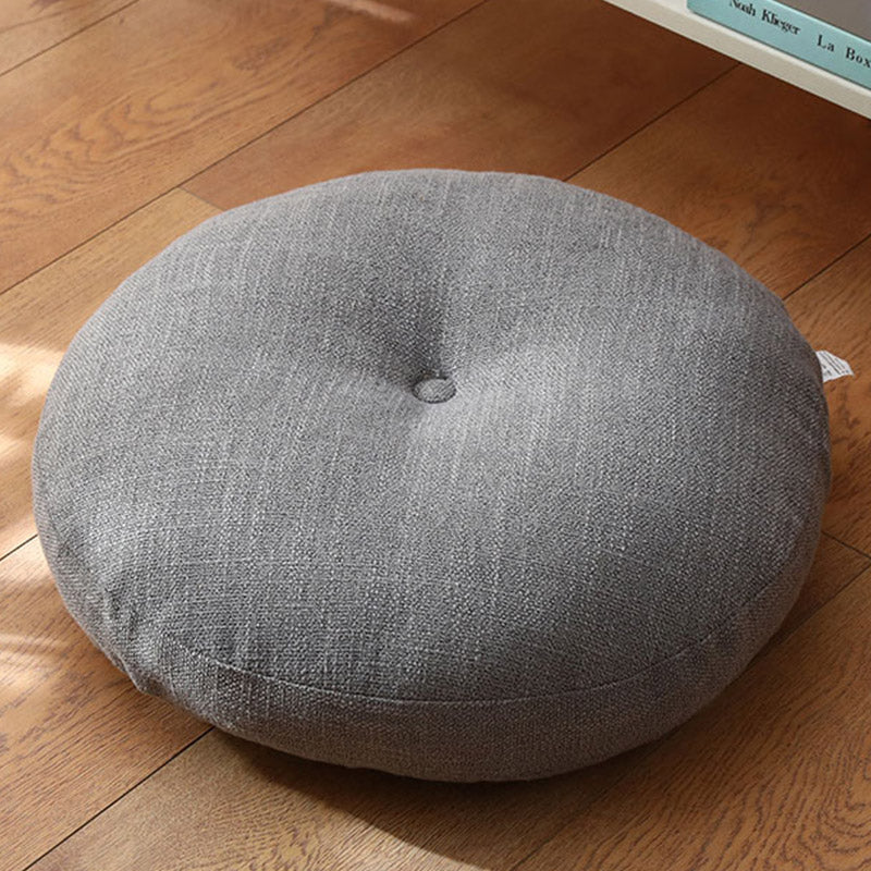 Lotus Linen Meditation Cushion – Gray tufted round pad on hardwood floor, zen seating