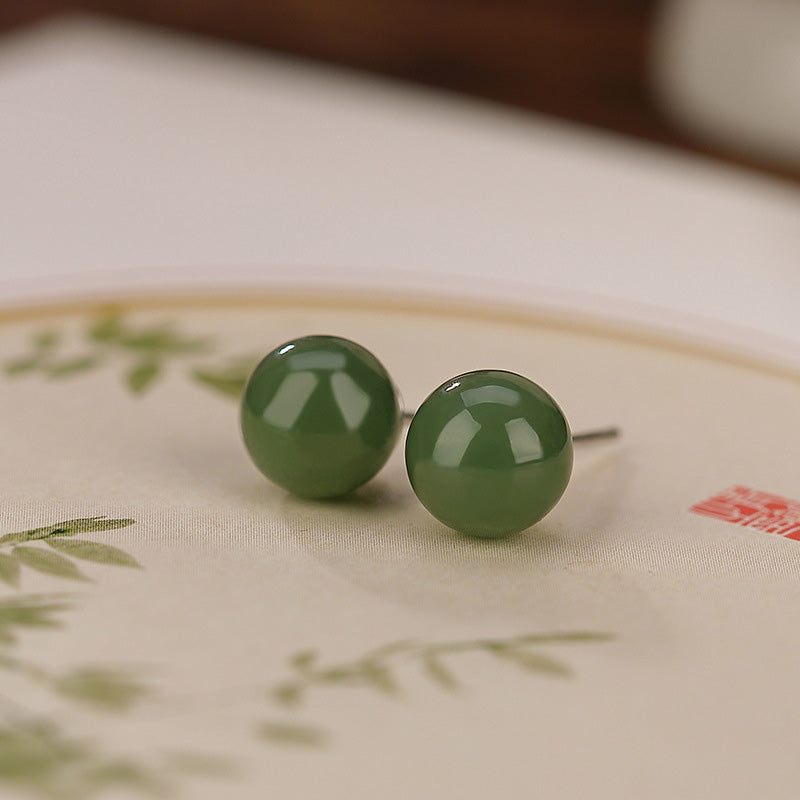 925 Silver Cyan Jade Healing Stud Earrings – sage green jade studs on traditional painted silk with bamboo motif, macro side view
