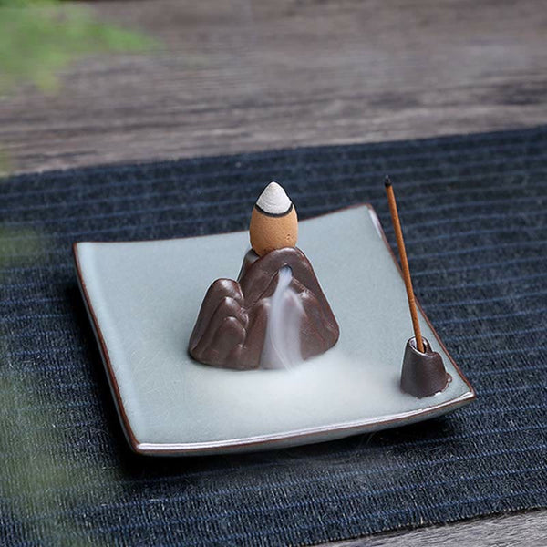 Lotus Ceramic Backflow Incense Burner - mountain sculpture with waterfall smoke pooling on green ceramic base
